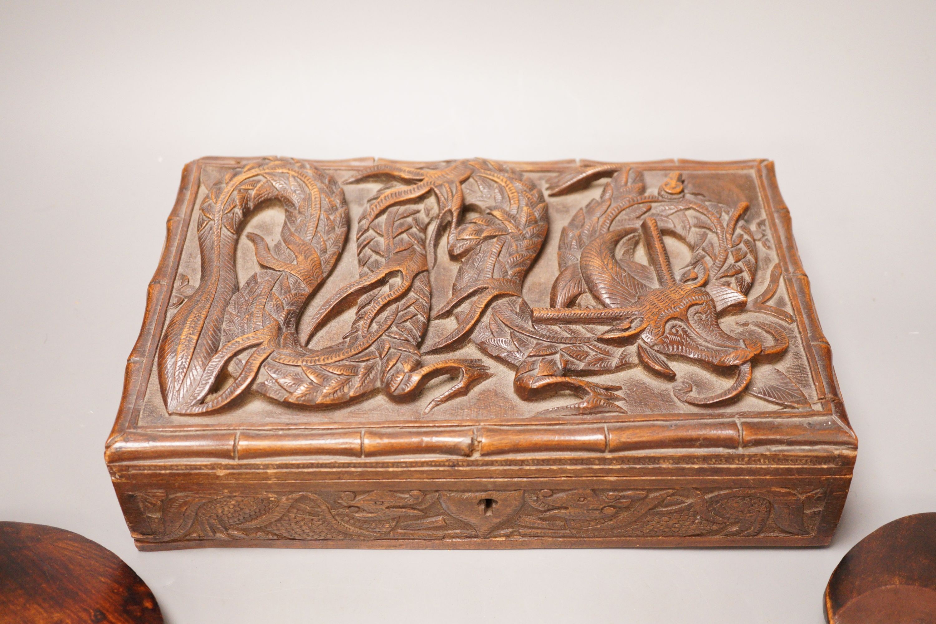 Two carved African wooden figures, together with a Burmese carved dragon wooden box